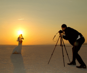 Husband taking a photo of his wife during sunset on a Desert Safari In Dubai