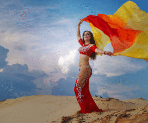 Woman performing traditional dance in cultural attire at Dubai Desert Safari entertainment show.